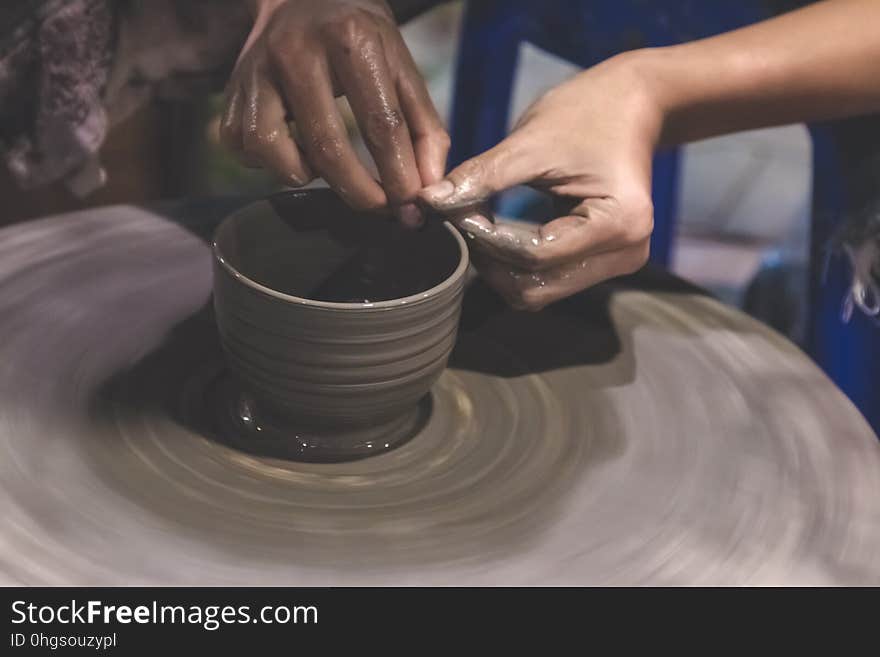 Professional Thai man using mechanic pottery make mug, earthenware at Night Plaza Market in Thailand. Professional Thai man using mechanic pottery make mug, earthenware at Night Plaza Market in Thailand.