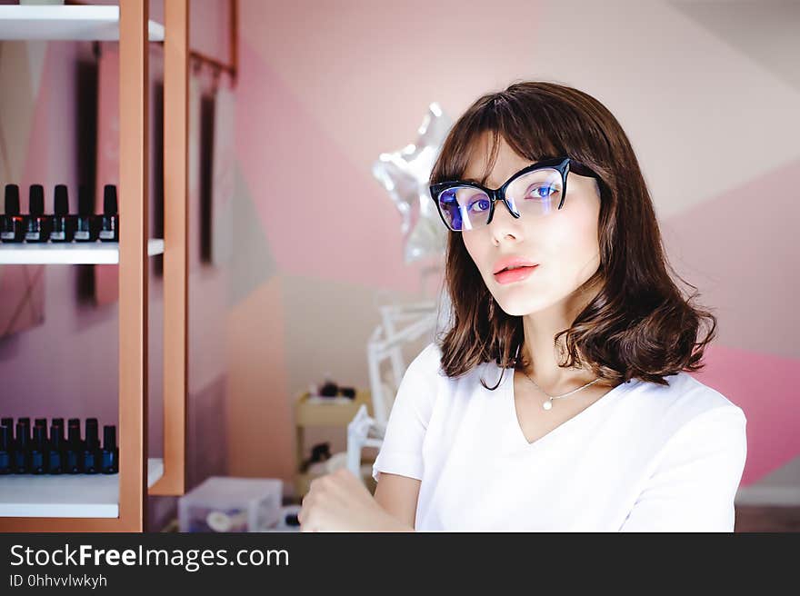 Portrait of a beautiful woman with pink lips in glasses. Portrait of a beautiful woman with pink lips in glasses.