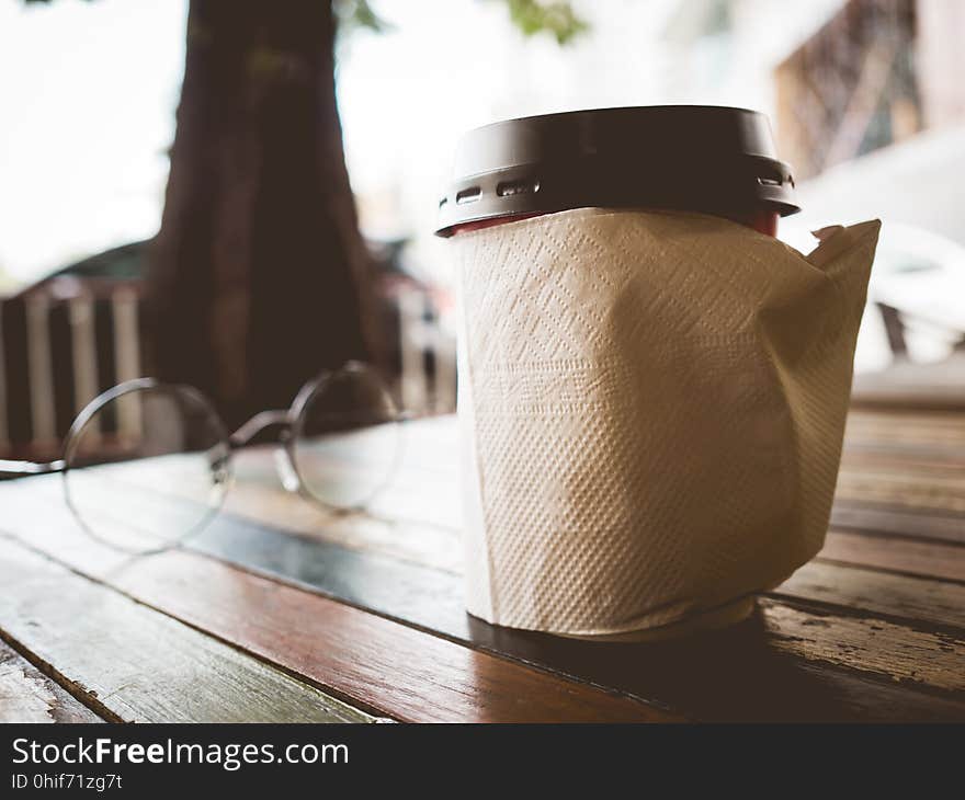 Hot coffee cup on wooden table.