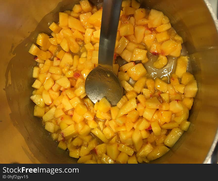 Peaches cooking with pectin, lemon juice, and butter