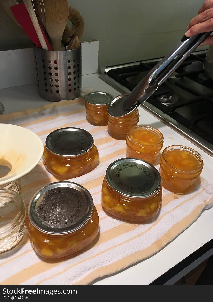 Covering clean, wiped jars with lids