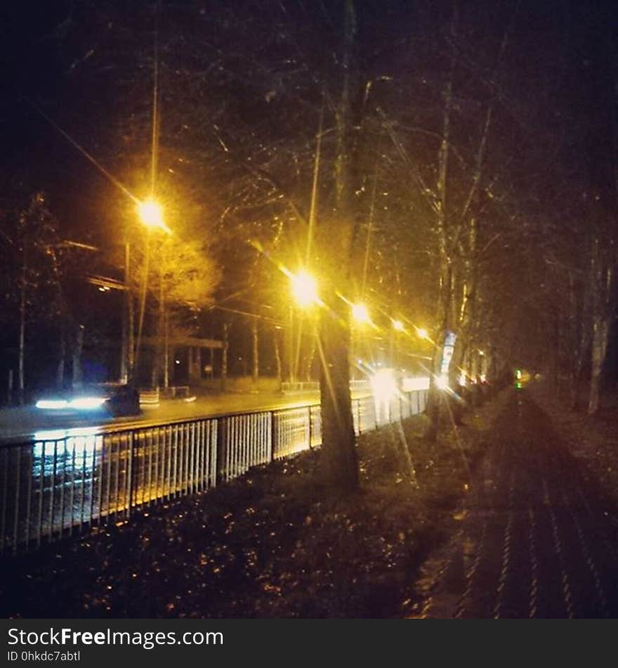 A quiet night street next to a pedestrian pathway. A quiet night street next to a pedestrian pathway.