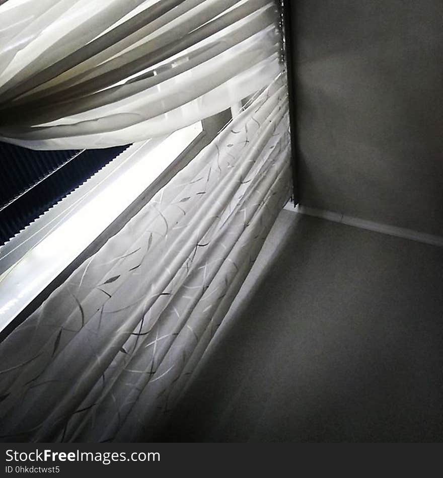 An angled view of partially open curtains.