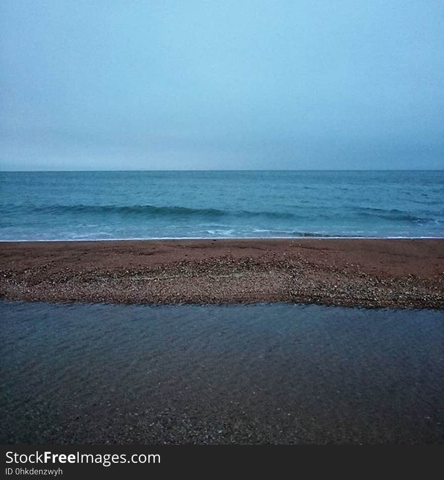 An empty beach at low tide.