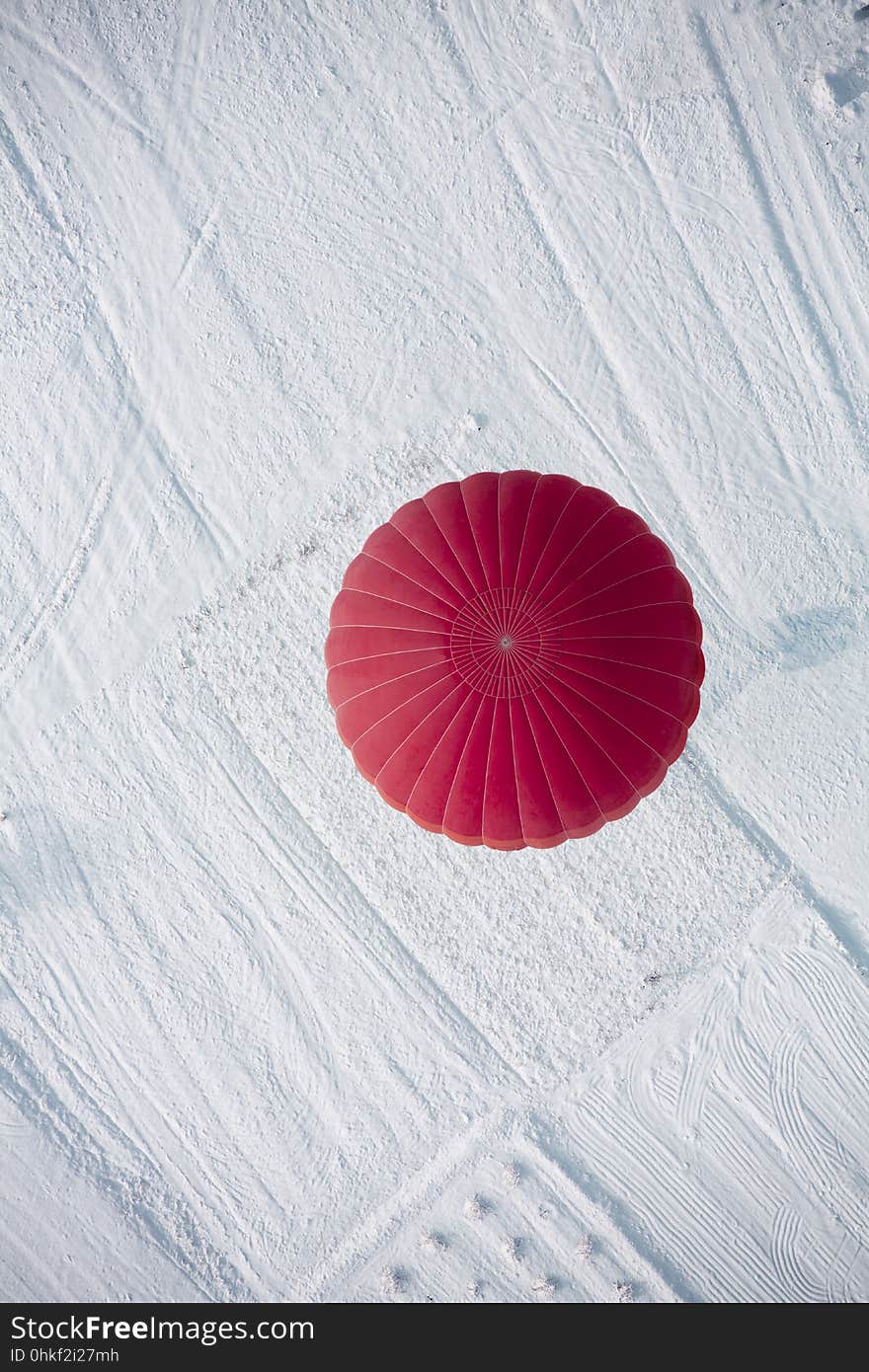 Hot air balloon landing view from top during winter in Cappadocia. Hot air balloon landing view from top during winter in Cappadocia