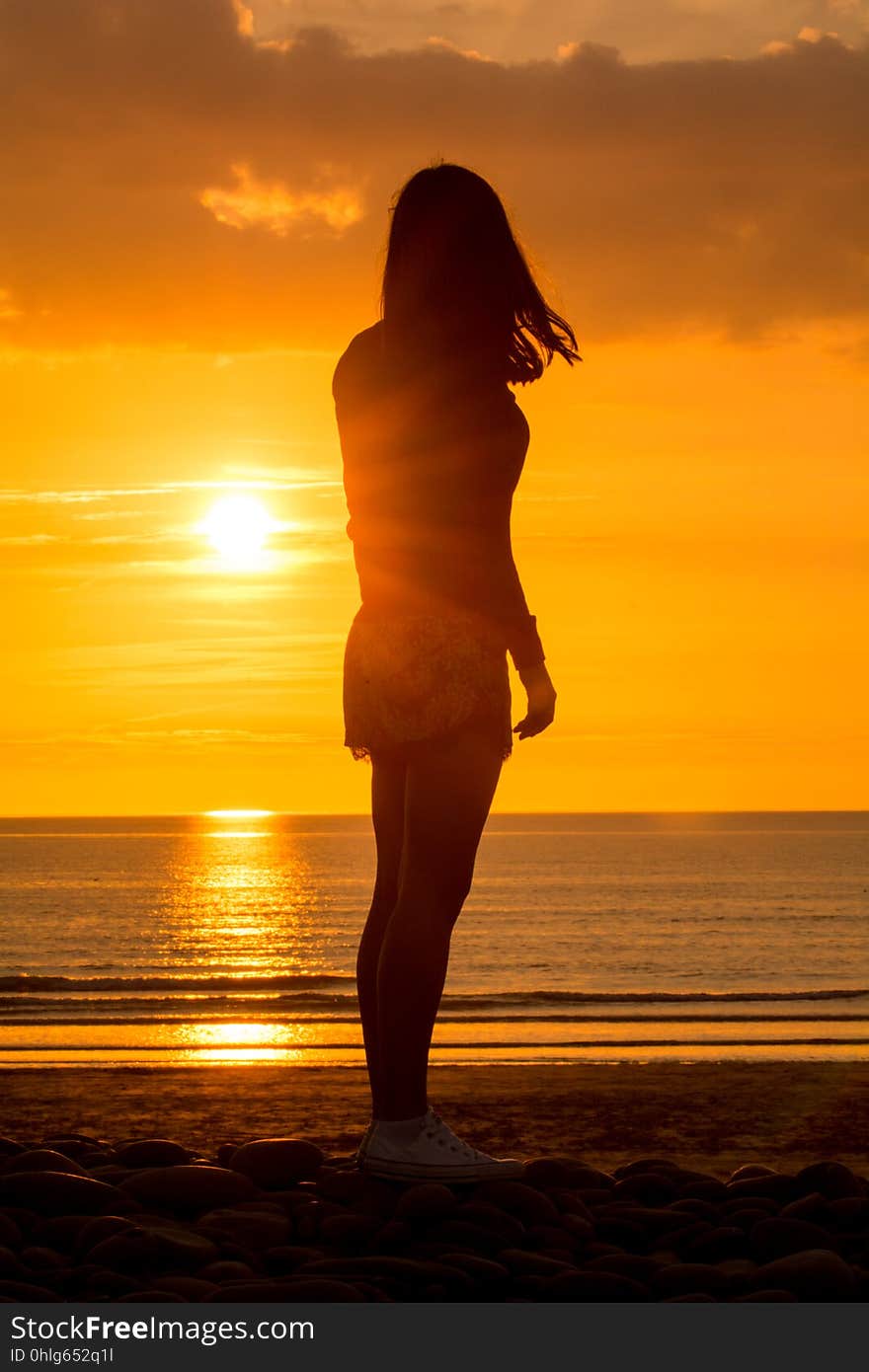 Yoga Woman doing yoga pose outside in sunset