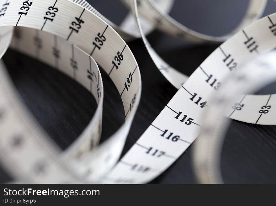 Measuring tape in a spiral. Closeup, macro. Fashion instrument. Measuring tape in a spiral. Closeup, macro. Fashion instrument.