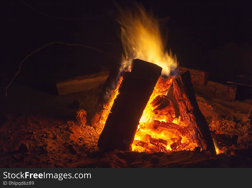 Hot fireplace full of wood and fire burning, bonfire at the camp