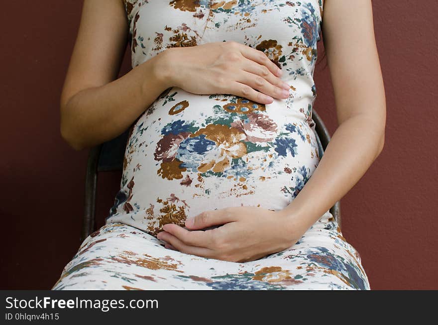 Close up shot of pregnant woman holding her baby in her tummy. Close up shot of pregnant woman holding her baby in her tummy