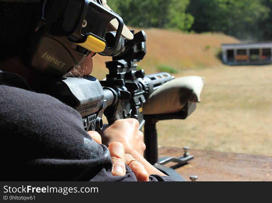 A close up of a man with a snipe outdoor. A close up of a man with a snipe outdoor.