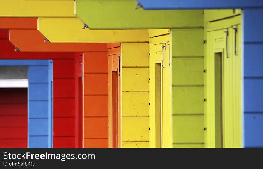 A closeup of homes painted in different colours. A closeup of homes painted in different colours.