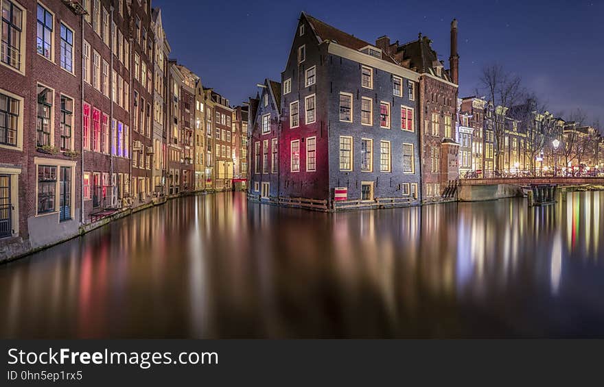 There are parts of Amsterdam that looks like you are in Venice. This scene of Amsterdam gives you a view behind the houses of the Red Light District. On the left you can see some of the red light coming out of the windows, reflecting on the house on the other side. [ Facebook ] [ Google+ ] [ Website ]. There are parts of Amsterdam that looks like you are in Venice. This scene of Amsterdam gives you a view behind the houses of the Red Light District. On the left you can see some of the red light coming out of the windows, reflecting on the house on the other side. [ Facebook ] [ Google+ ] [ Website ]