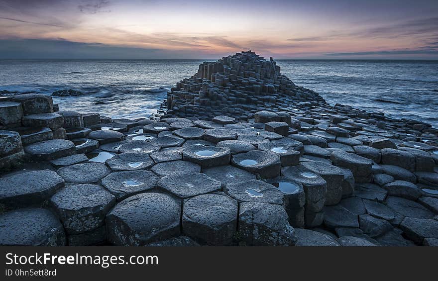 Rocks along beach at sunset. Rocks along beach at sunset.