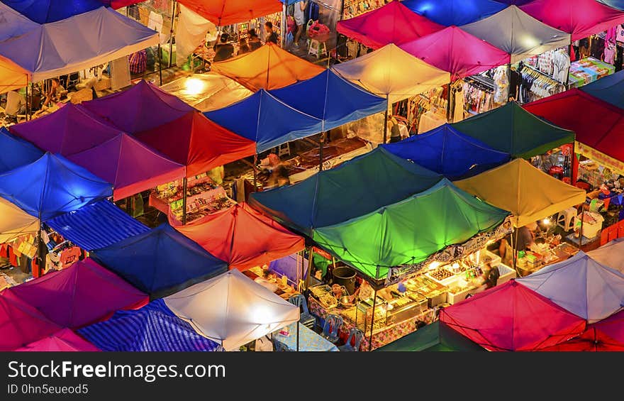 Colorful canopies over stalls in outdoor market at night. Colorful canopies over stalls in outdoor market at night.