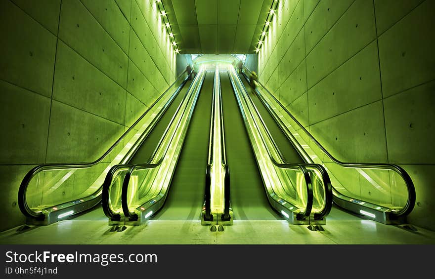 Four escalators in a subway station. Four escalators in a subway station.