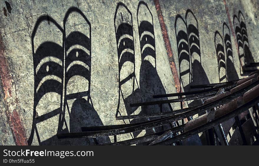 The shadows of chair backrests on a wall. The shadows of chair backrests on a wall.