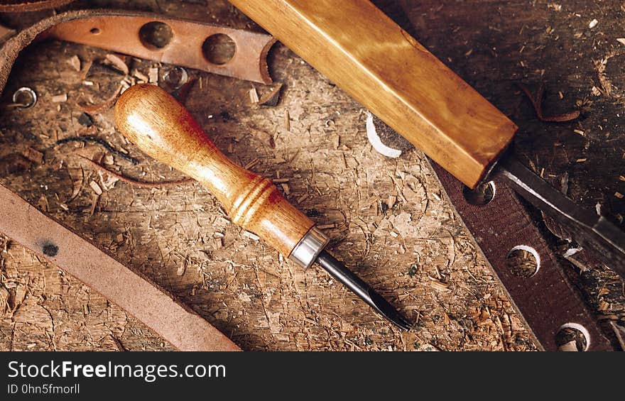 Close-up of tools and waste leather on table. Close-up of tools and waste leather on table