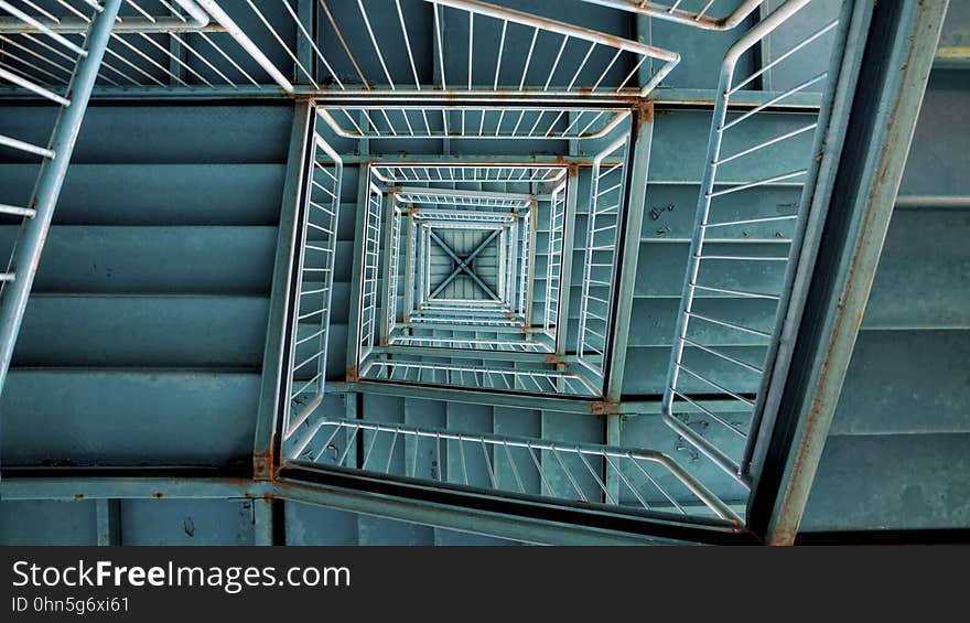 A winding staircase and a stairwell seen from below. A winding staircase and a stairwell seen from below.