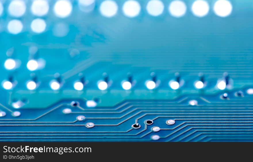 Closeup of a blue electronic circuit board showing (wire) tracks and an array of white light emitting diodes. Closeup of a blue electronic circuit board showing (wire) tracks and an array of white light emitting diodes.