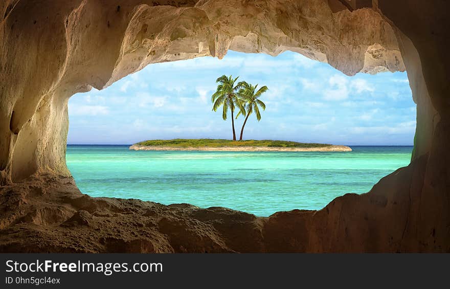 An old Indian cave located on a remoteTurks and Caicos Island. Beautiful Caribbean sea glowing and warm sunlight bathing some remote palm trees on a deserted island. An old Indian cave located on a remoteTurks and Caicos Island. Beautiful Caribbean sea glowing and warm sunlight bathing some remote palm trees on a deserted island.