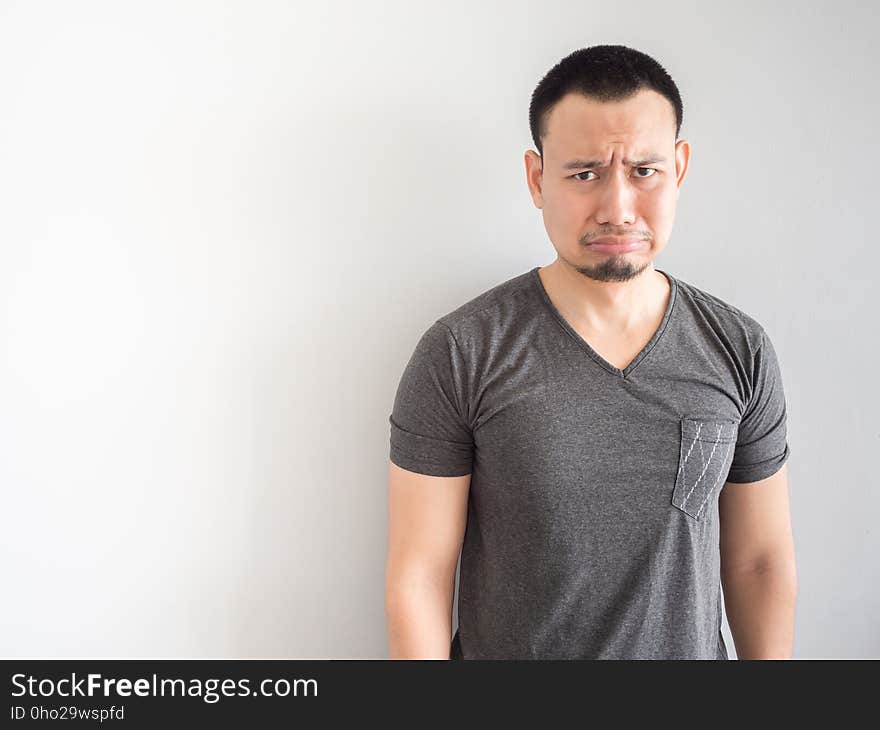 Sad and scared asian man in black t-shirt.