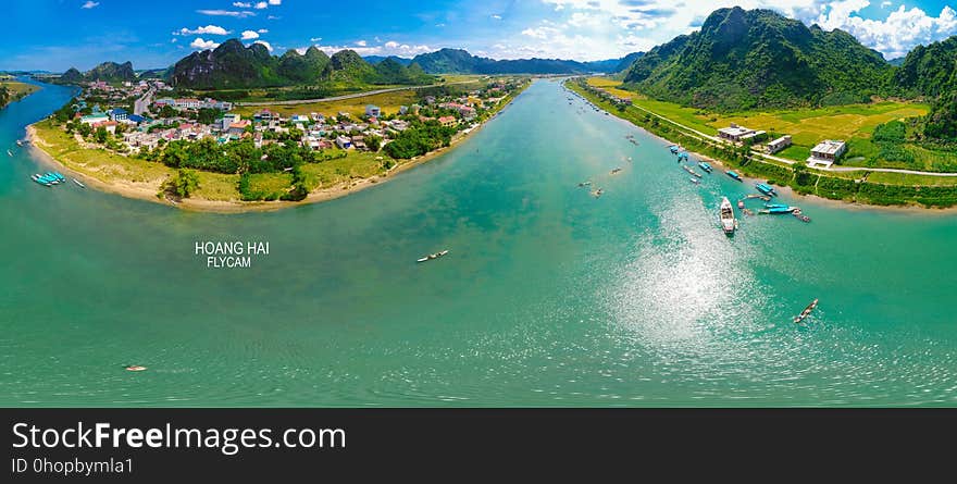 Aerial view of coastline along waterway on sunny day. Aerial view of coastline along waterway on sunny day.