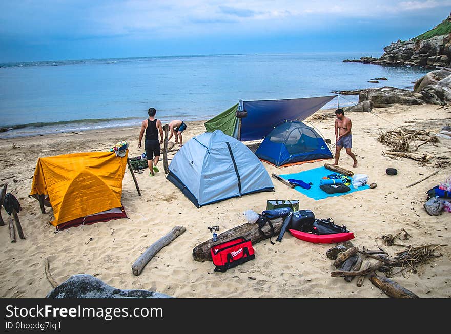 Tents in campsite on sandy beach along waterfront. Tents in campsite on sandy beach along waterfront.