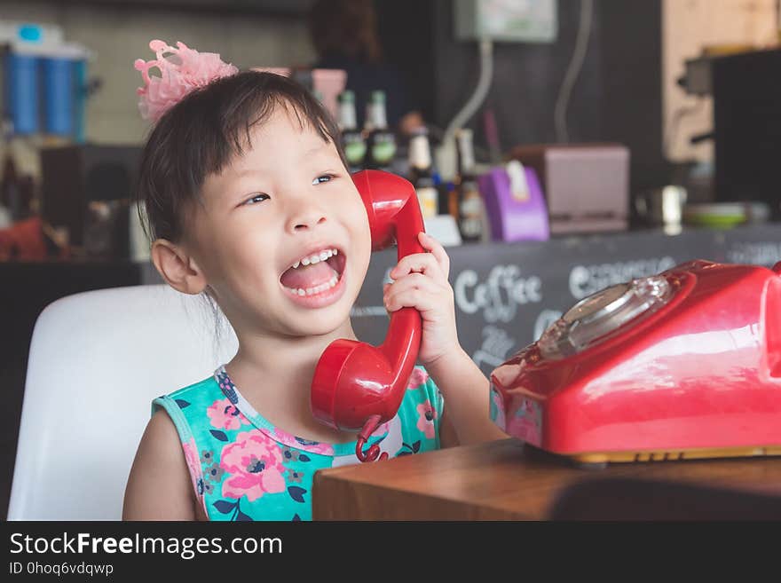 Girl smiling while talking with her friend by phone