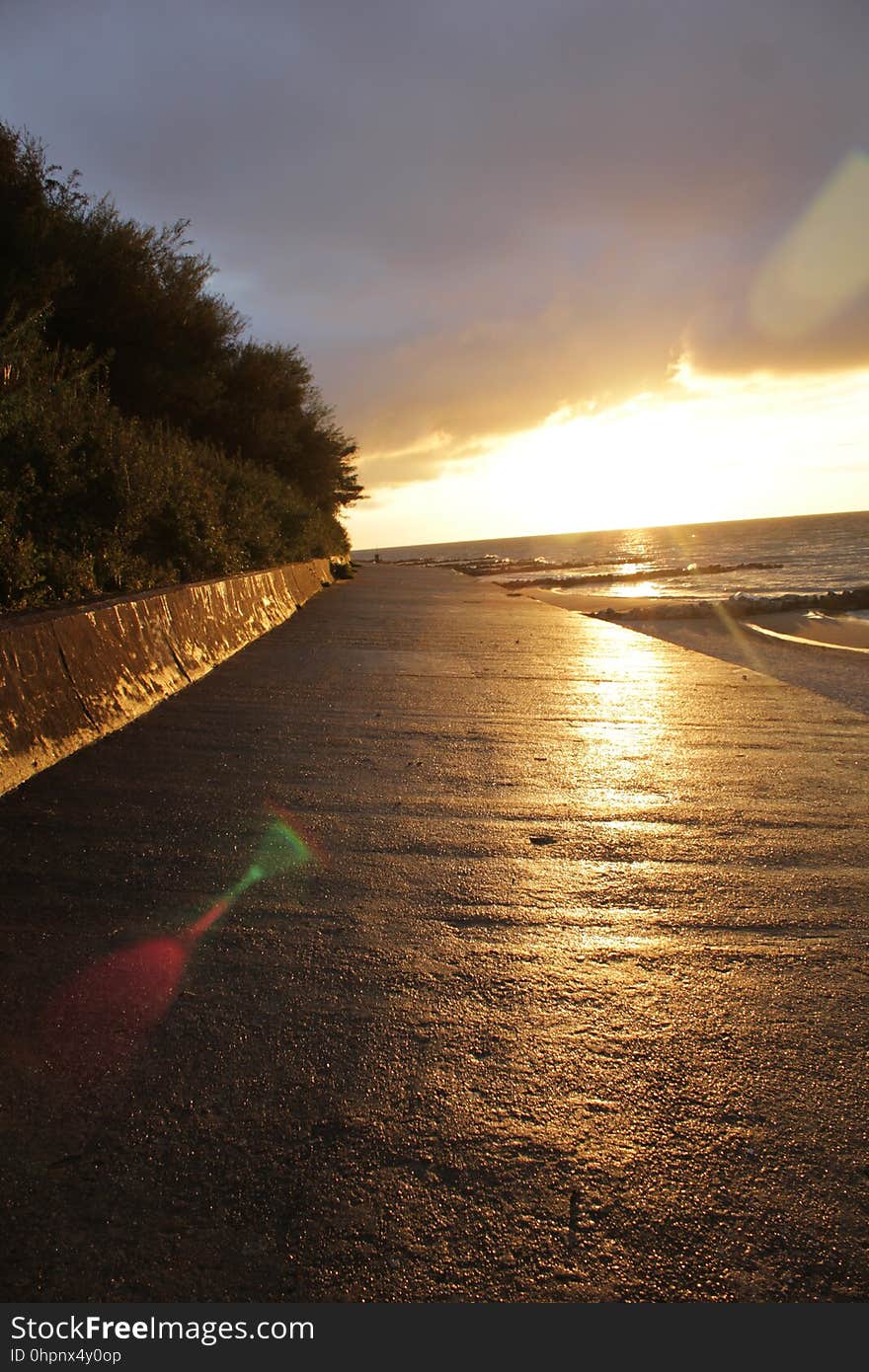 An empty promenade by the sea at sunset. An empty promenade by the sea at sunset.