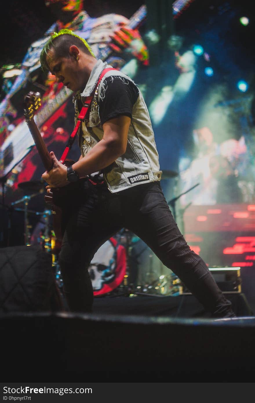 A guitarist plays at a rock concert.