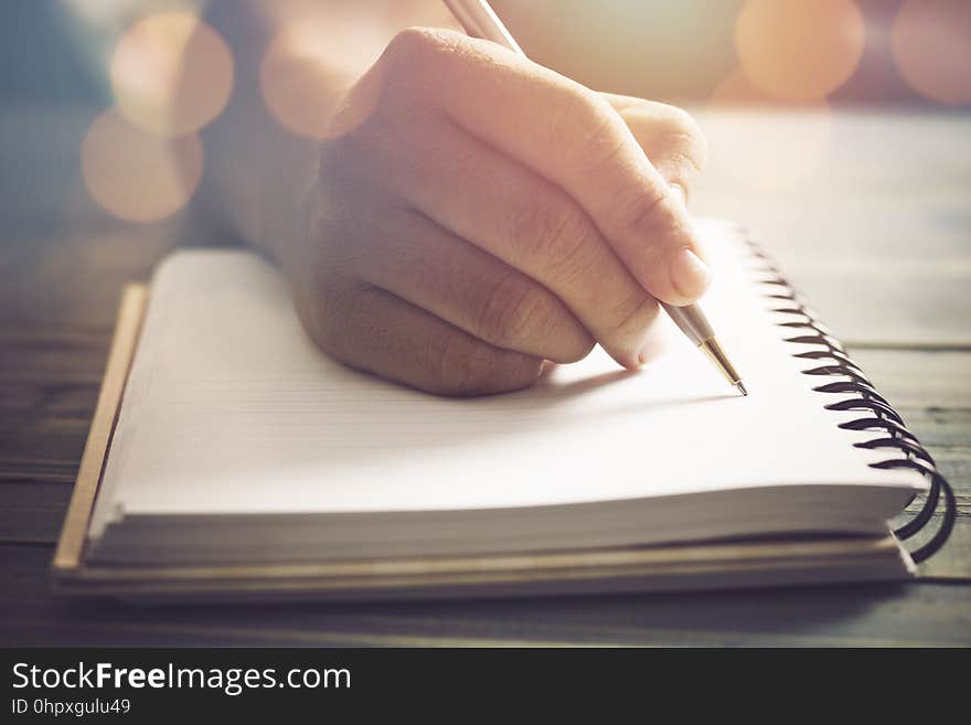 Hand of people, student writing and note on notebook on wood table with copy space, in library, concept as education attempt and m