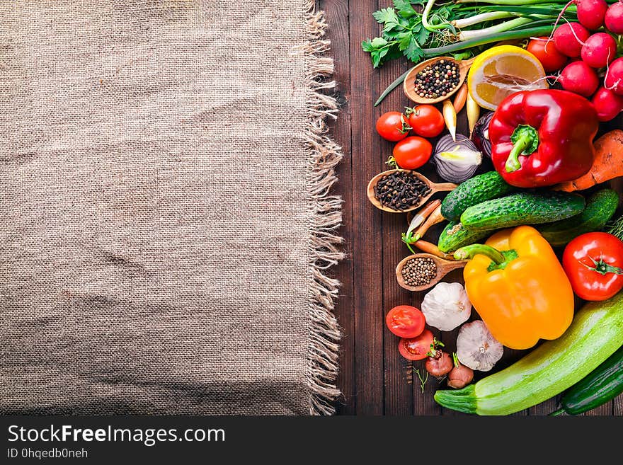 Frame of organic food. Fresh raw vegetables and spices. On a wooden chalkboard.