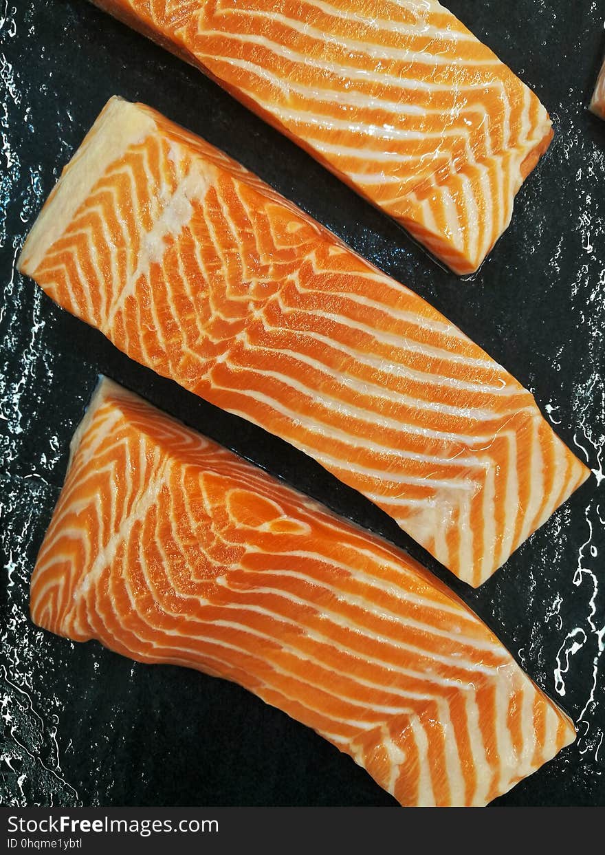 salmon fillet in front of black background