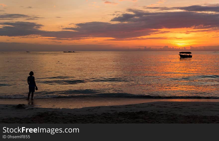 Here&#x27;s my wife admiring the sunrise in Punta Cana, Dominican Republic. The dark objects near the horizon on the left side are all that remains of the Astron, a Russian freighter that ran aground in 1978 while delivering corn to Cuba. There&#x27;s very little left above the water now. Here&#x27;s my wife admiring the sunrise in Punta Cana, Dominican Republic. The dark objects near the horizon on the left side are all that remains of the Astron, a Russian freighter that ran aground in 1978 while delivering corn to Cuba. There&#x27;s very little left above the water now.