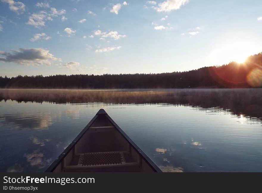 Canoe bow as the sun clears the trees at Pog Lake. Canoe bow as the sun clears the trees at Pog Lake.