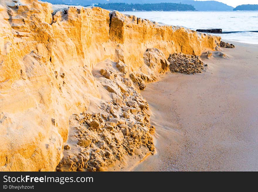 Sand texture of the colored sand cliffs on beach