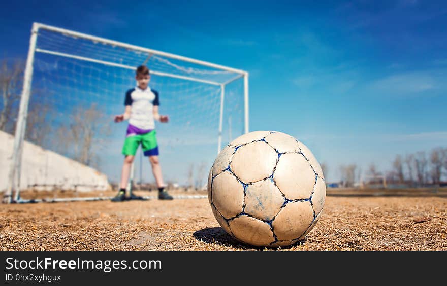 Young caucasian boy teenager goalkeeper catches ball goal soccer. Young caucasian boy teenager goalkeeper catches ball goal soccer