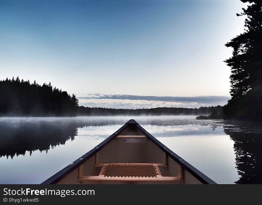 Canoeing across Pog Lake, Algonquin Provincial Park, in the misty morning. Canoeing across Pog Lake, Algonquin Provincial Park, in the misty morning.