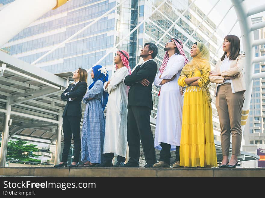 Multiethnic group of businesspeople meeting outdoors in a city background.