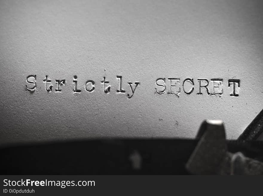 Old retro typewriter with the written text Strictly SECRET with focus on all words. Old retro typewriter with the written text Strictly SECRET with focus on all words