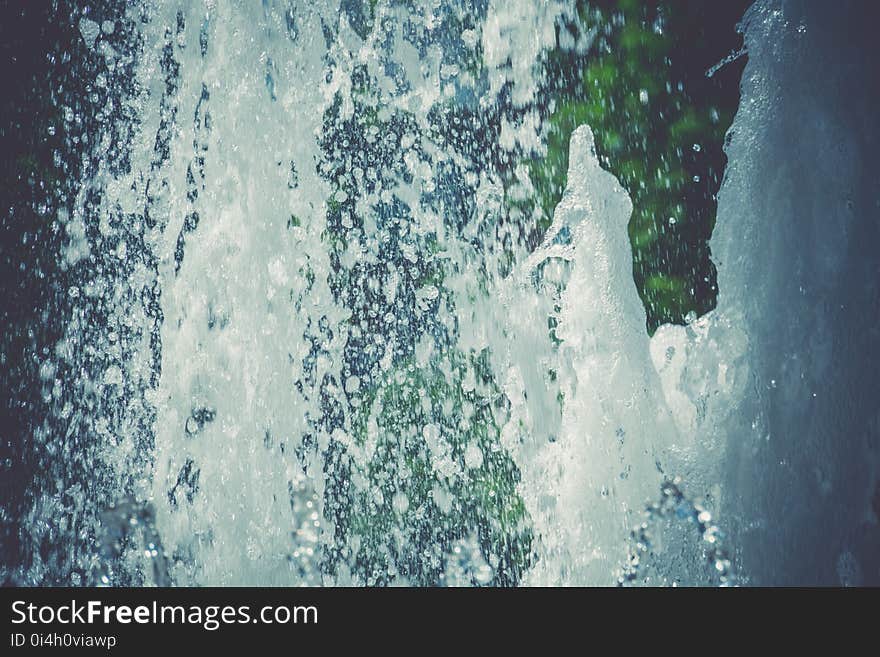 Splashing water in the city park fountain at the summer day, filtered background. Splashing water in the city park fountain at the summer day, filtered background.