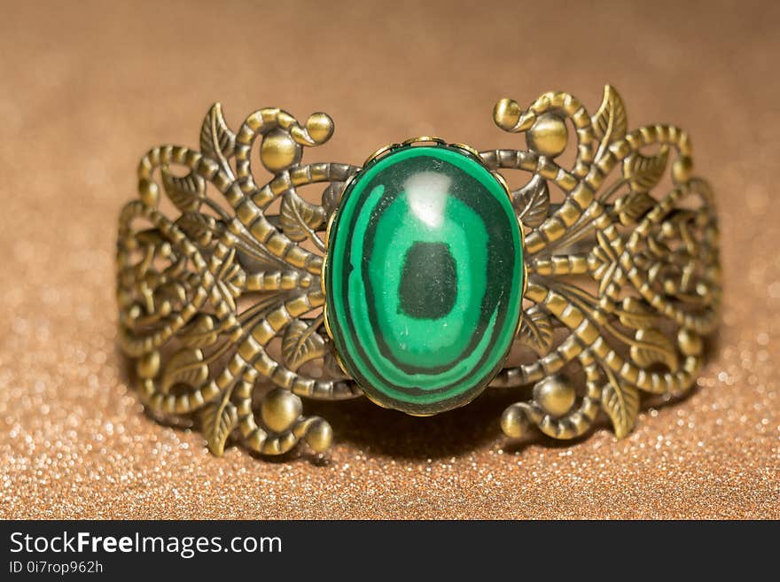 Vintage ornamental bronze bracelet with big green stone malachite imitation. Vintage ornamental bronze bracelet with big green stone malachite imitation.