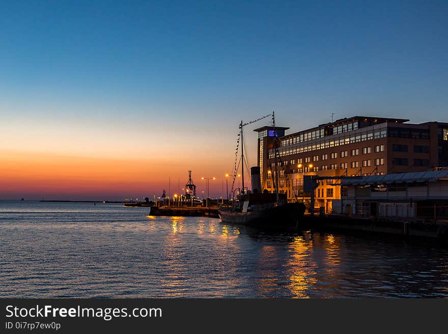 Buildings and boats at sunset in Malmo harbour Sweden looking out to the Baltic sea. Buildings and boats at sunset in Malmo harbour Sweden looking out to the Baltic sea