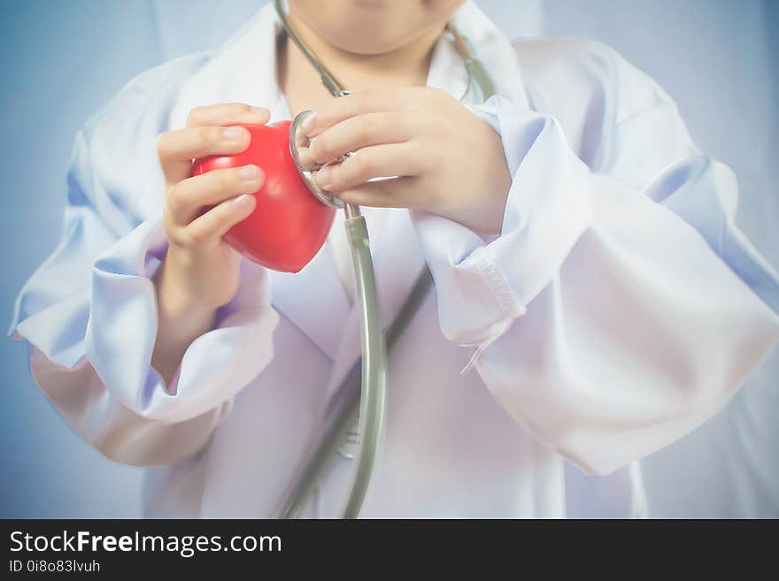 Asian girl playing as a doctor care healthy heart