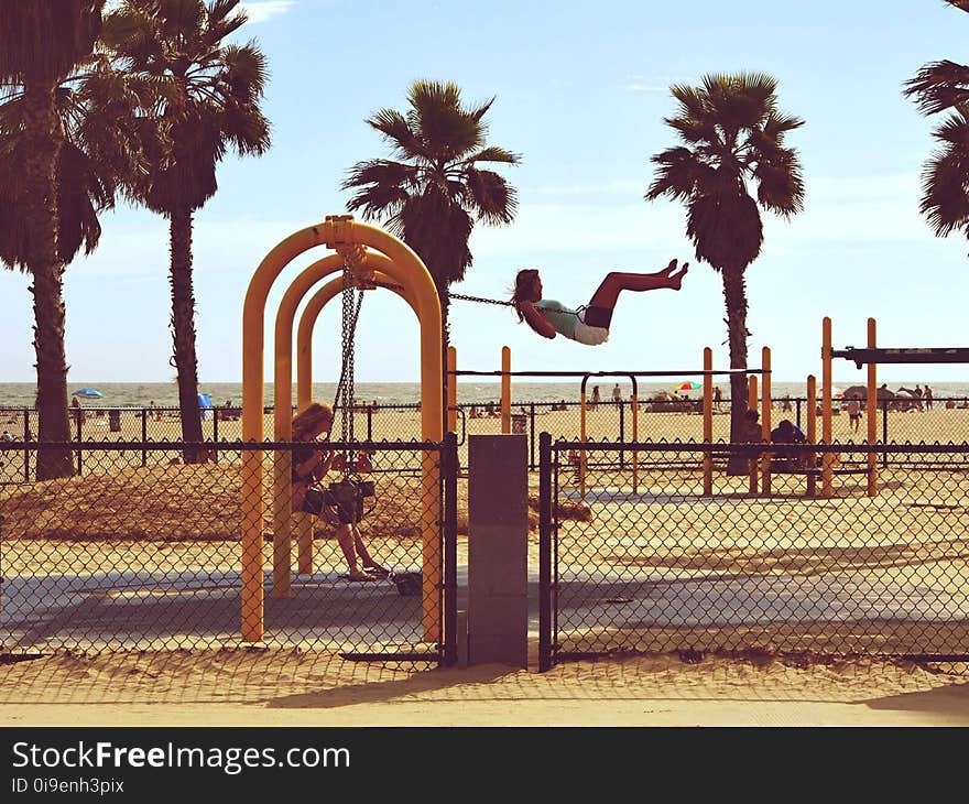 Woman Playing Swing Near Beach