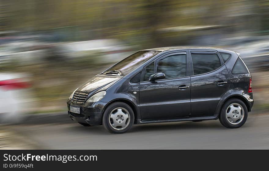 A compact Mercedes car on a blurred background. A compact Mercedes car on a blurred background.