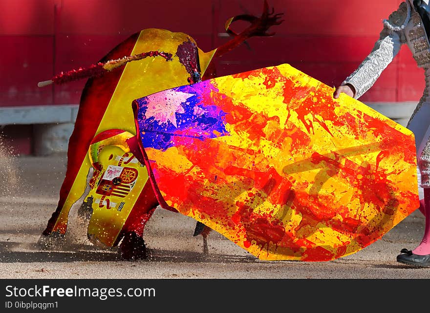 Symbol of crisis relations between countries. A bullfighter giving a pass to the bull with his cape. Flags of Spain and Catalonia.