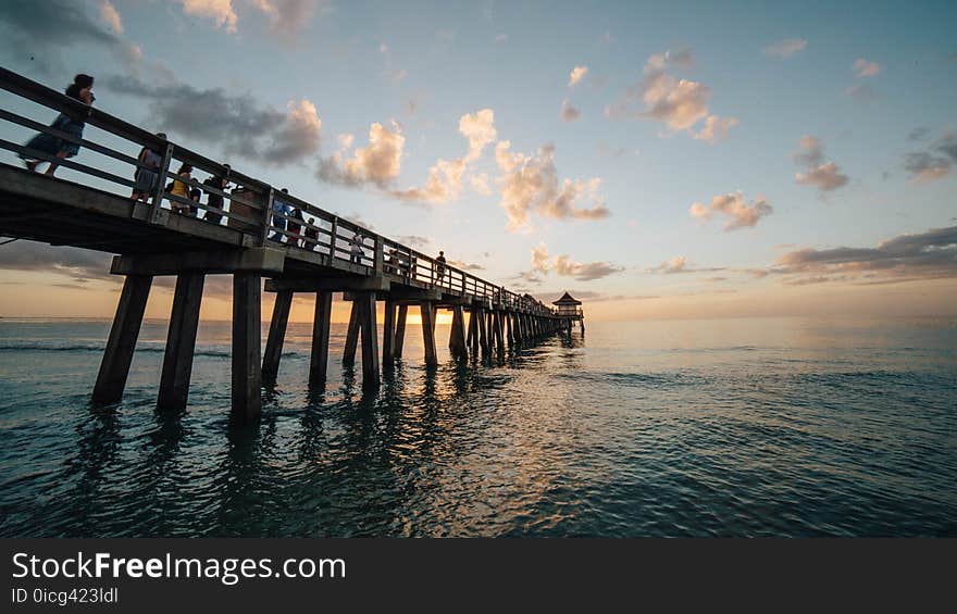 Pier on Sea Against Cloudy Sky