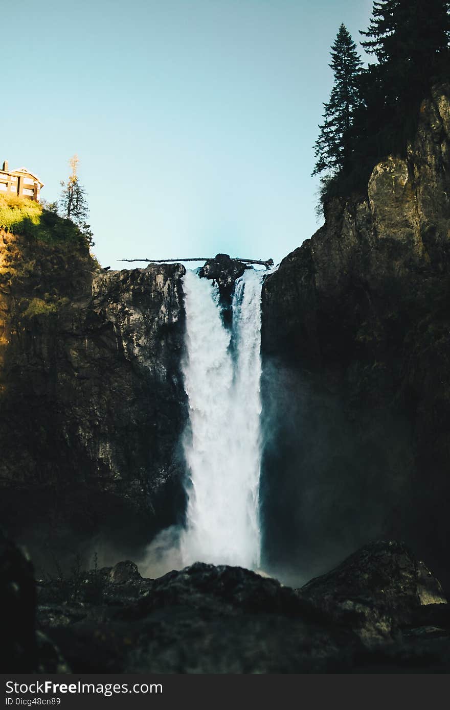 Waterfalls Near House Under Clear Blue Sky