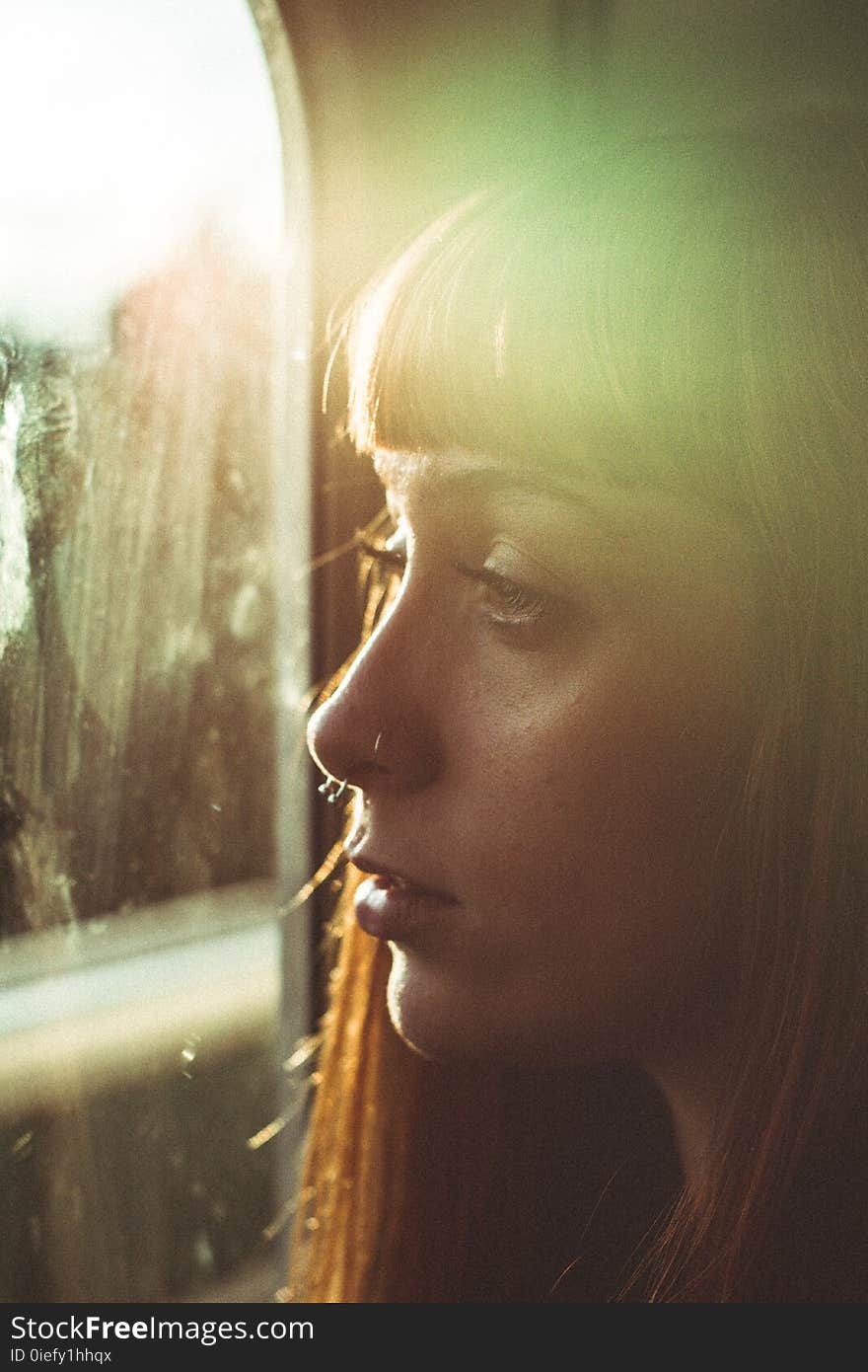 Woman Looking Through a Window